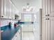 Efficient kitchen with white cabinetry, blue countertops, and a window above the sink providing natural light at 2802 Swifton Dr # V102, Sarasota, FL 34231