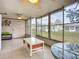 Bright lanai with a tiled floor, screened windows, and backyard views at 2802 Swifton Dr # V102, Sarasota, FL 34231