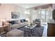 Stylish living room with a comfortable sofa, patterned rug, and natural light at 2802 Swifton Dr # V102, Sarasota, FL 34231