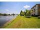 Backyard boasts waterfront view, well-manicured grassy lawn, and lush foliage, all under a sunny sky at 3015 Chianti Ct # 104, Sarasota, FL 34237