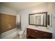 Bathroom featuring vanity, tile surround tub, and modern fixtures at 3015 Chianti Ct # 104, Sarasota, FL 34237