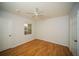 This bedroom features hardwood floors, a ceiling fan, a window for natural light, and neutral wall paint at 3015 Chianti Ct # 104, Sarasota, FL 34237