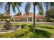 A beautiful community clubhouse surrounded by lush lawns, mature trees, and colorful landscaping at 3015 Chianti Ct # 104, Sarasota, FL 34237