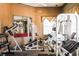 Gym featuring various weightlifting machines, dumbbells, mirrors, and rubberized floors for workouts at 3015 Chianti Ct # 104, Sarasota, FL 34237