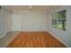 Neutral living room offers ample natural light, wood floors and ceiling fan at 3015 Chianti Ct # 104, Sarasota, FL 34237