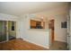 Open floor plan features wood flooring, neutral paint, and access to the kitchen at 3015 Chianti Ct # 104, Sarasota, FL 34237