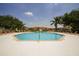 Inviting community pool surrounded by lounging chairs and the complex buildings at 3015 Chianti Ct # 104, Sarasota, FL 34237
