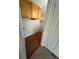 An organizational storage area with wood flooring, upper cabinets, and built-in shelving for tidy storing at 3015 Chianti Ct # 104, Sarasota, FL 34237