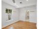 Bedroom with hardwood floors, ceiling fan, recessed lighting, and large windows for natural light at 322 35Th Ne Ave, St Petersburg, FL 33704