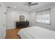 Bedroom with hardwood floors, ceiling fan, dresser, and large window providing natural light at 322 35Th Ne Ave, St Petersburg, FL 33704
