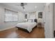 Bright bedroom with hardwood floors, ceiling fan, and large windows featuring colorful sheer curtains at 322 35Th Ne Ave, St Petersburg, FL 33704