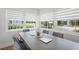 Bright dining area with a contemporary table and chairs set under natural light streaming through the window at 322 35Th Ne Ave, St Petersburg, FL 33704