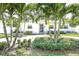 Beautiful, single-story home featuring a well-manicured front yard with mature palm trees and lush landscaping at 322 35Th Ne Ave, St Petersburg, FL 33704