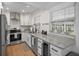 Modern kitchen featuring white cabinets, stainless steel appliances, and granite countertops at 322 35Th Ne Ave, St Petersburg, FL 33704