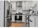 Bright kitchen features stainless steel appliances, granite countertops, and white subway tile backsplash at 322 35Th Ne Ave, St Petersburg, FL 33704