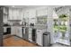 Bright, remodeled kitchen with granite countertops, white cabinetry, and stainless steel appliances at 322 35Th Ne Ave, St Petersburg, FL 33704