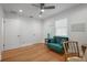 Cozy room with hardwood floors, neutral walls, green love seat, and wooden desk with chair at 322 35Th Ne Ave, St Petersburg, FL 33704