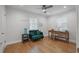 Cozy room with hardwood floors, neutral walls, green love seat, and wooden desk with chair at 322 35Th Ne Ave, St Petersburg, FL 33704
