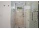 Modern shower with white marble tile, rainfall shower head, and glass door at 322 35Th Ne Ave, St Petersburg, FL 33704