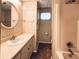 Bathroom featuring a vanity with a mirror and a shower-tub combo at 3221 Sweet Bay Ter, Sarasota, FL 34237