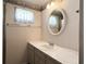 Bathroom view with single sink vanity, mirror, and decorative wallpaper border at 3221 Sweet Bay Ter, Sarasota, FL 34237