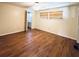 Bedroom featuring hardwood floors, a window with blinds, and an ensuite bathroom at 3221 Sweet Bay Ter, Sarasota, FL 34237