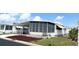 Charming home with covered parking and screened in porch and awnings at 3221 Sweet Bay Ter, Sarasota, FL 34237
