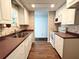 Spacious kitchen with wood floors, white appliances, and a view into the dining area at 3221 Sweet Bay Ter, Sarasota, FL 34237