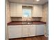Kitchen with white cabinetry, stainless steel sink, and a window for natural light at 3221 Sweet Bay Ter, Sarasota, FL 34237