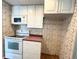 A kitchen with appliances, white cabinets, and ample storage at 3221 Sweet Bay Ter, Sarasota, FL 34237