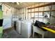 Utility room area featuring a washer, dryer, sink, and overhead and side wall shelving at 3221 Sweet Bay Ter, Sarasota, FL 34237