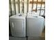Functional laundry area featuring a modern dryer and washer, and natural light from an overhead bulb at 3221 Sweet Bay Ter, Sarasota, FL 34237
