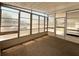 Enclosed patio with large windows and a door to the outside, featuring neutral carpet at 3221 Sweet Bay Ter, Sarasota, FL 34237