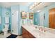Bathroom featuring double mirrored medicine cabinets and a walk-in shower at 338 Indian Key Way # 111, Englewood, FL 34223