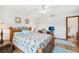Spacious bedroom featuring a view to the ensuite bathroom and a ceiling fan at 338 Indian Key Way # 111, Englewood, FL 34223