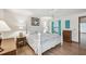 Bright bedroom featuring a four-poster bed, wood floors and a ceiling fan at 338 Indian Key Way # 111, Englewood, FL 34223
