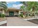 Attractive clubhouse exterior with landscaping, benches, and clearly marked unit numbers and entry at 338 Indian Key Way # 111, Englewood, FL 34223