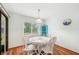 Bright dining room features a white table and chairs, a window, and wood-look flooring at 338 Indian Key Way # 111, Englewood, FL 34223