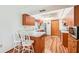 A charming kitchen features warm wood cabinetry, a breakfast bar, and modern appliances at 338 Indian Key Way # 111, Englewood, FL 34223