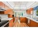 Bright kitchen offers wood cabinetry, quartz countertops, and a breakfast bar with a view at 338 Indian Key Way # 111, Englewood, FL 34223