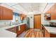 Kitchen features wood cabinets, stainless steel appliances, and a view to the backyard at 338 Indian Key Way # 111, Englewood, FL 34223