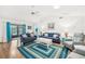 Well-lit living area showcasing hardwood floors, ample seating, and modern decor at 338 Indian Key Way # 111, Englewood, FL 34223