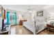 The main bedroom showcases ample natural light, hardwood floors, and a calming color palette at 338 Indian Key Way # 111, Englewood, FL 34223