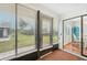 Enclosed sunroom showcases sliding windows and a view to the backyard at 338 Indian Key Way # 111, Englewood, FL 34223