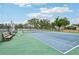 Clean tennis court features nice landscaping with benches for relaxing in between games at 338 Indian Key Way # 111, Englewood, FL 34223
