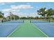 Beautifully maintained tennis courts with clear blue and green surfaces, perfect for a game on a sunny day at 338 Indian Key Way # 111, Englewood, FL 34223