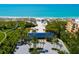 Aerial view of beach access, community building, and parking near the ocean at 340 Gulf Of Mexico Dr # 124, Longboat Key, FL 34228
