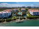 A beautiful aerial view showcases this waterfront condo community with a pool, dock, and manicured landscaping at 340 Gulf Of Mexico Dr # 124, Longboat Key, FL 34228
