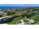 Aerial view of a lush golf course surrounded by scenic waterways and luxurious waterfront homes at 340 Gulf Of Mexico Dr # 124, Longboat Key, FL 34228