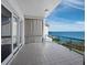 Balcony with tile floor, glass railing, and stunning view of the clear blue waters at 340 Gulf Of Mexico Dr # 124, Longboat Key, FL 34228